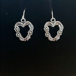 Handcrafted silver tone heart earrings.